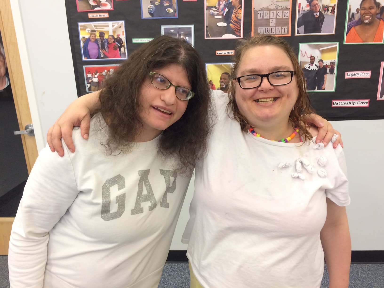 Two friends smiling together at a Delta Projects community gathering